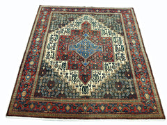 A vintage Persian Senneh rug featuring a central blue diamond medallion on a red and dark field.