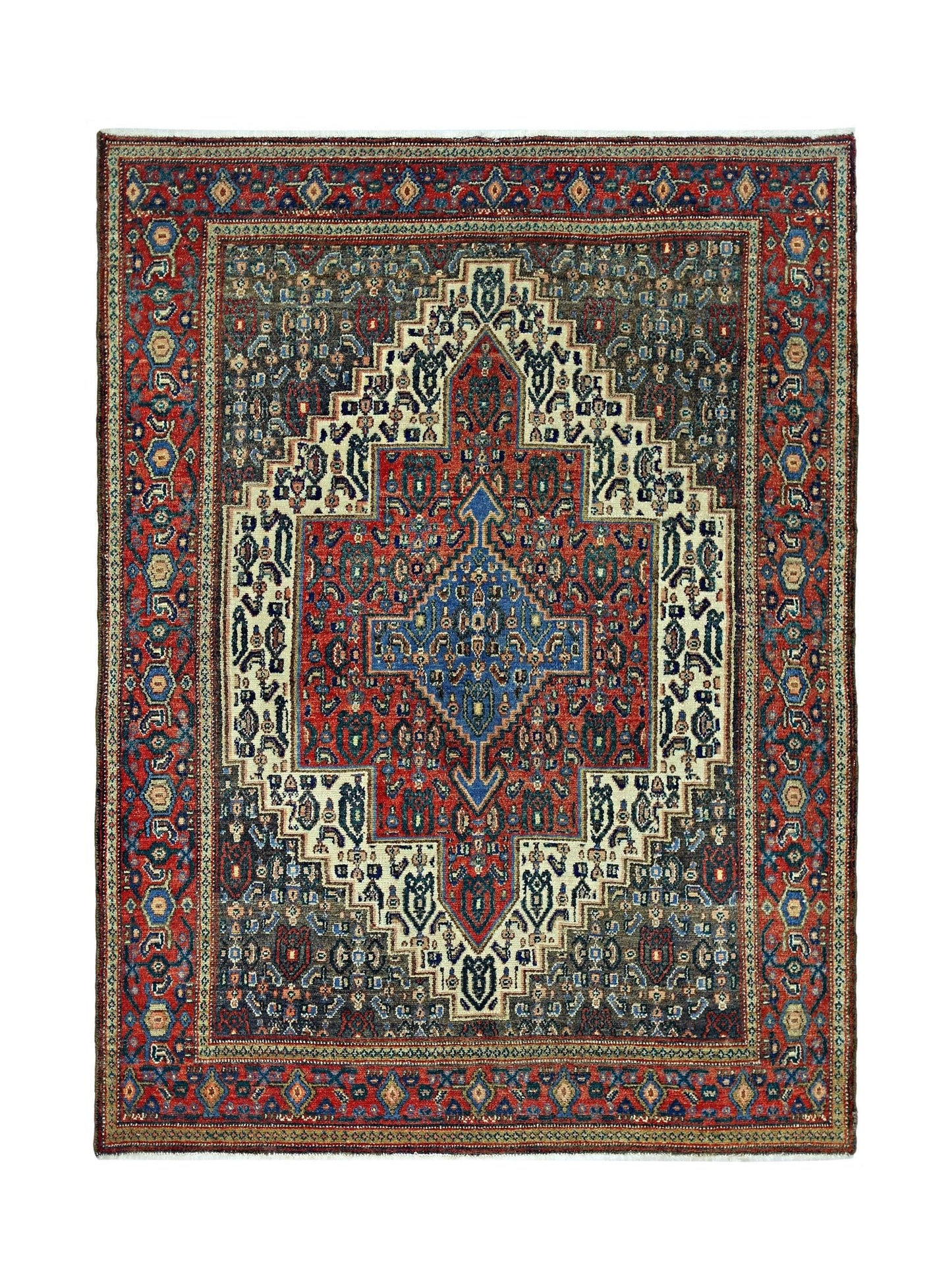 A vintage handmade Persian Senneh rug featuring a geometric medallion pattern in red and blue.