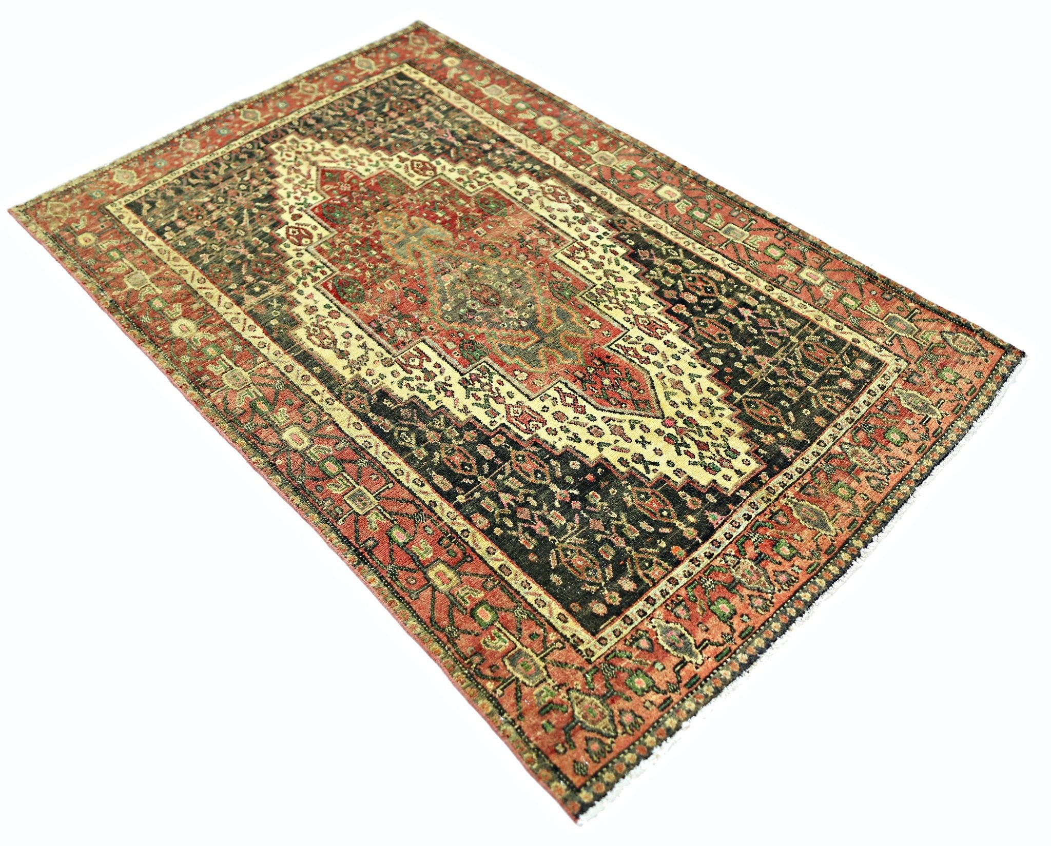 A vintage handmade Persian Sanandaj rug featuring a central medallion on a dark floral field.