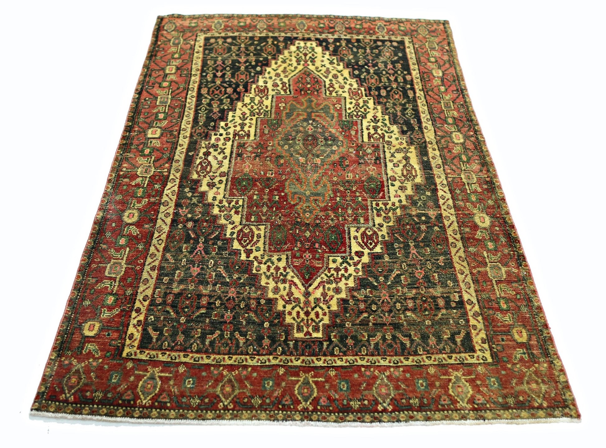 A vintage Persian Sanandaj rug featuring a central medallion on a dark field with red borders.