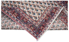 A vintage handwoven Persian Saraband rug featuring a repeating geometric pattern in red and blue.