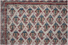 A vintage Persian Saraband rug featuring a repeating blue and tan boteh pattern on a cream field.