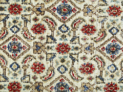 A vintage Persian Saraband rug featuring a repeating geometric pattern in red, blue, and tan.