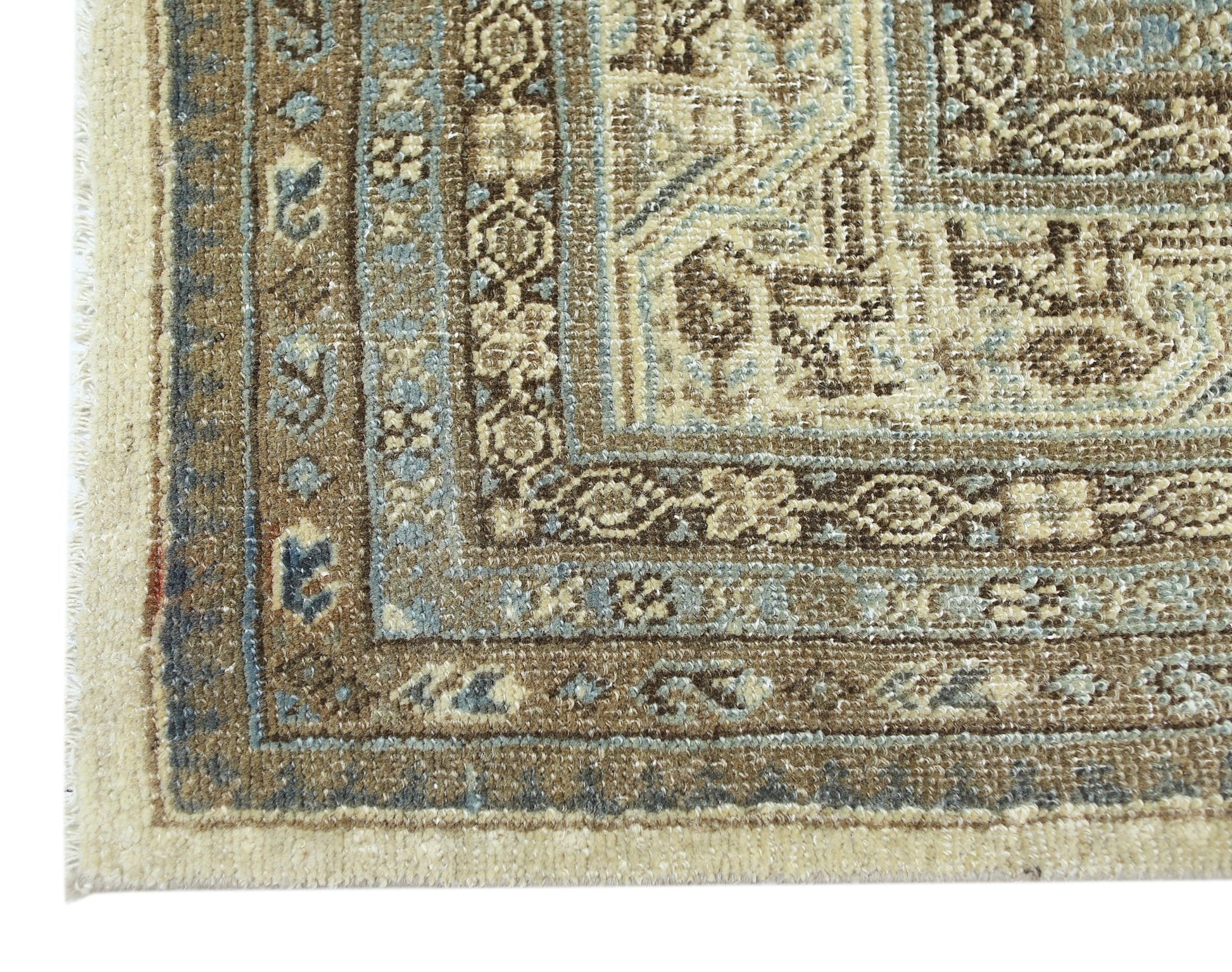 A corner view of a vintage Persian Saraband rug featuring intricate brown and blue floral patterns.