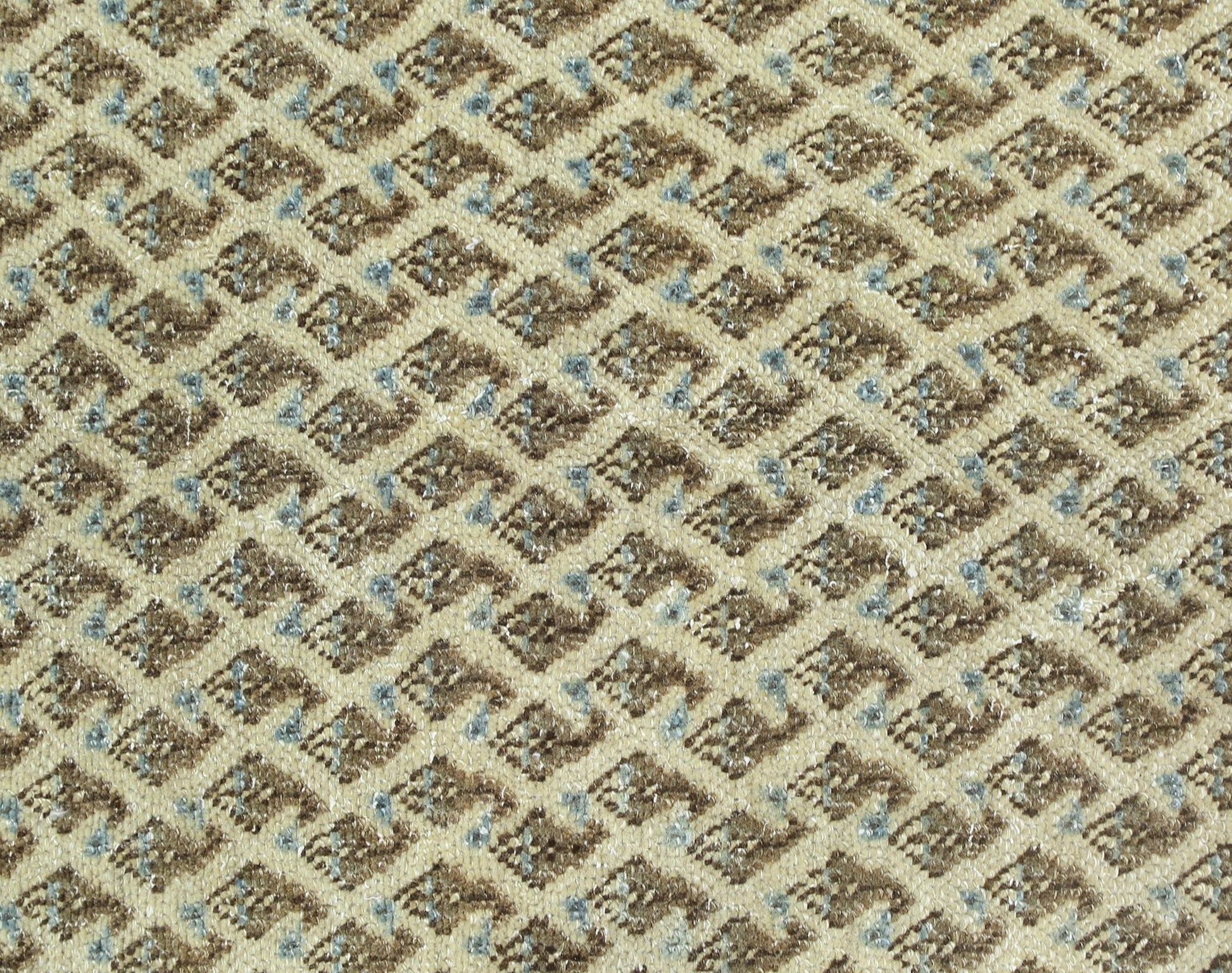 A close-up of a vintage Persian Saraband rug featuring a repeating geometric diamond pattern.