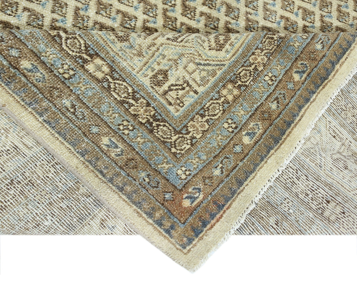 A vintage Persian Saraband rug featuring a geometric pattern in shades of blue, brown, and cream.