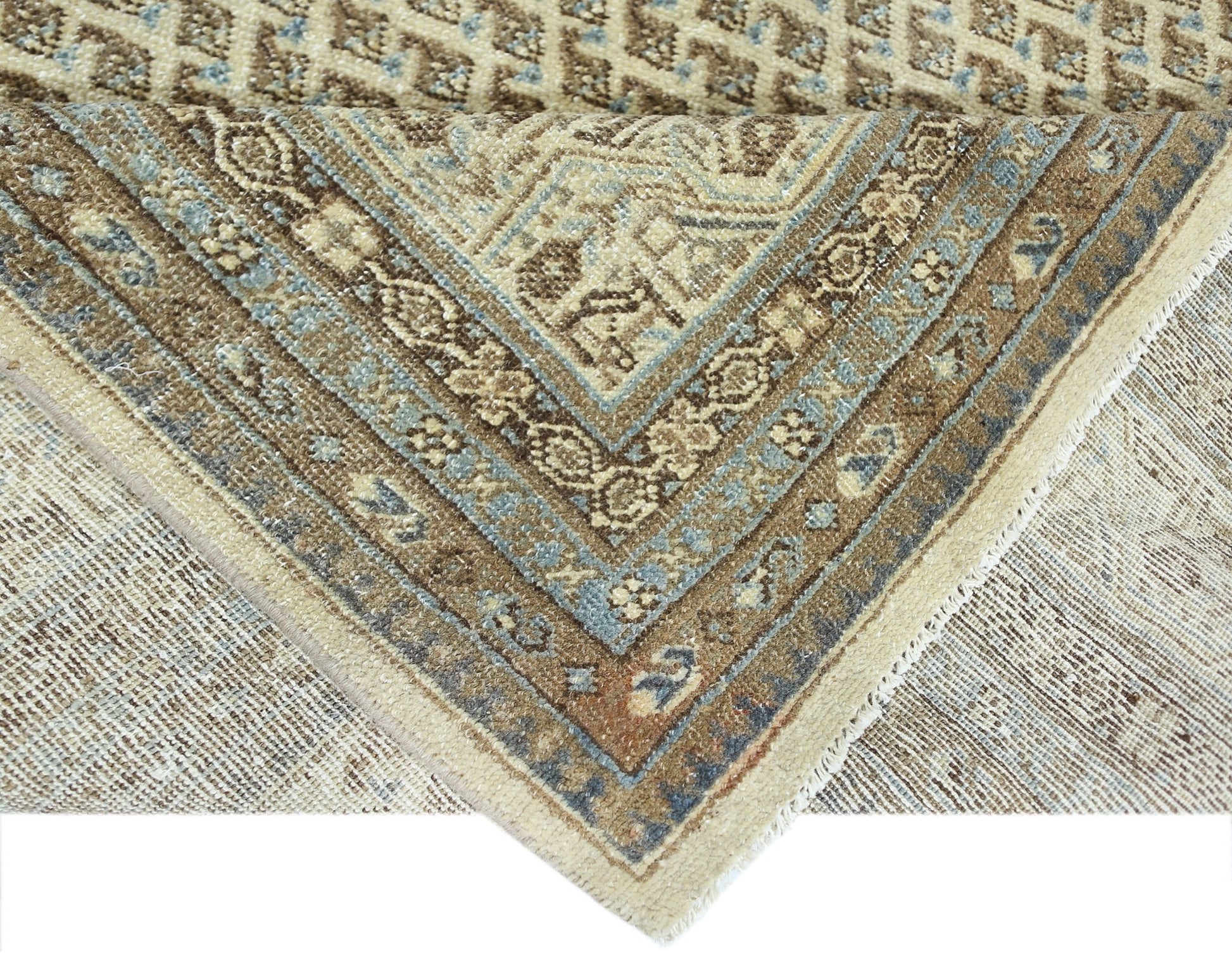 A vintage Persian Saraband rug featuring a geometric pattern in shades of blue, brown, and cream.