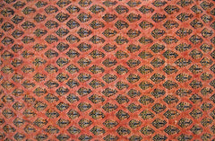 A vintage Persian Saraband rug featuring a repeating pattern of small boteh motifs on a red field.