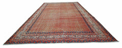 A vintage Persian Saraband rug featuring a repeating pattern in shades of red and blue.