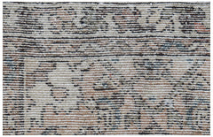 Mini vintage Persian rug with a distressed pattern in neutral tones.
