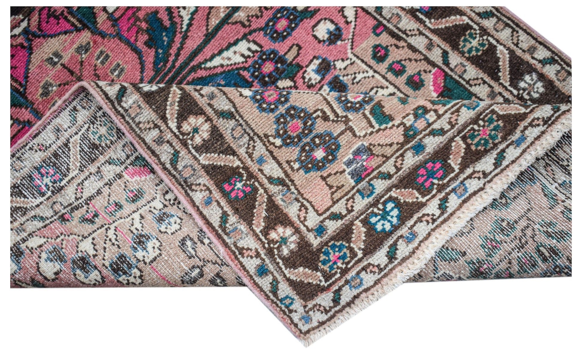 A vintage Persian Sarouk rug with a floral pattern in pink, blue, and brown tones.
