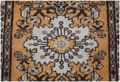 A vintage Persian rug featuring a central white floral medallion on an orange background.