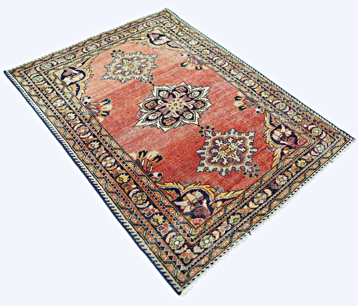 A rectangular vintage Persian rug featuring a red field with three central floral medallions.