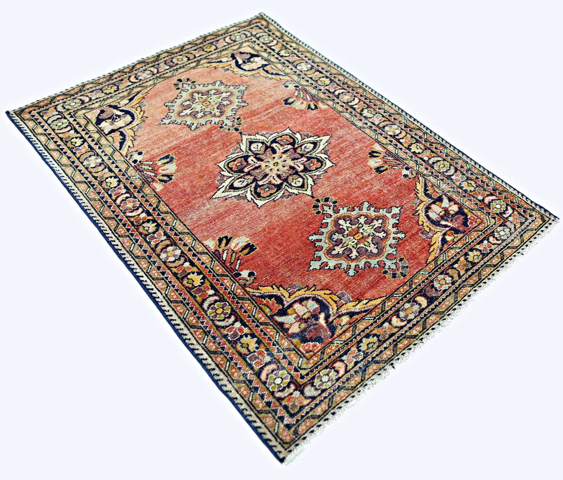 A rectangular vintage Persian rug featuring a red field with three central floral medallions.