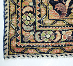 A corner view of a handmade vintage Persian rug featuring intricate floral patterns in wool.