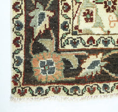 A corner view of a vintage Persian Sarouk rug featuring intricate floral patterns in wool.