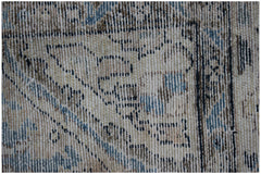 Close-up of a vintage Persian Sarouk rug featuring intricate floral patterns in blue and beige.