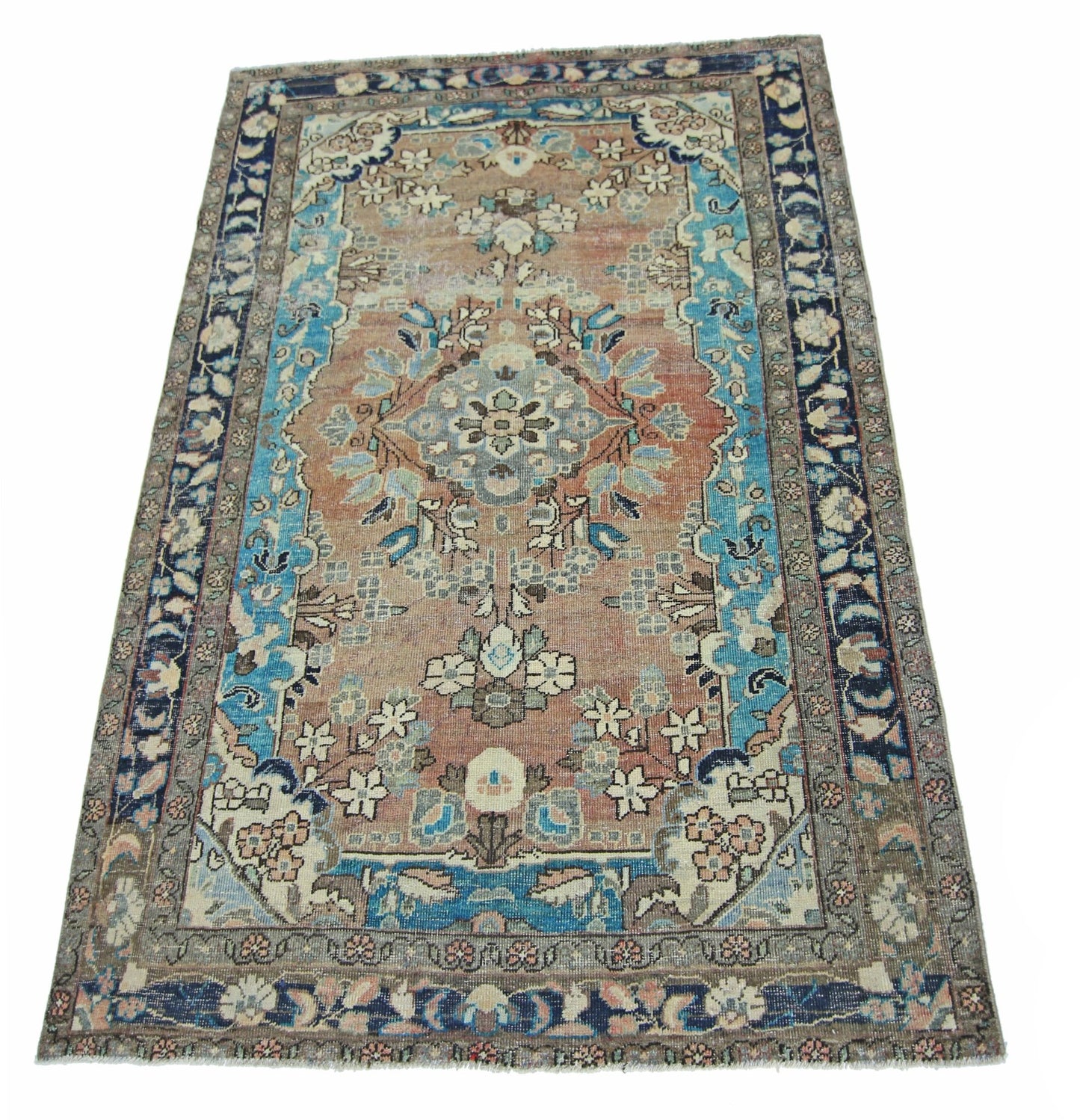A vintage handmade Persian Tabriz rug featuring a floral medallion pattern in blue and terracotta.