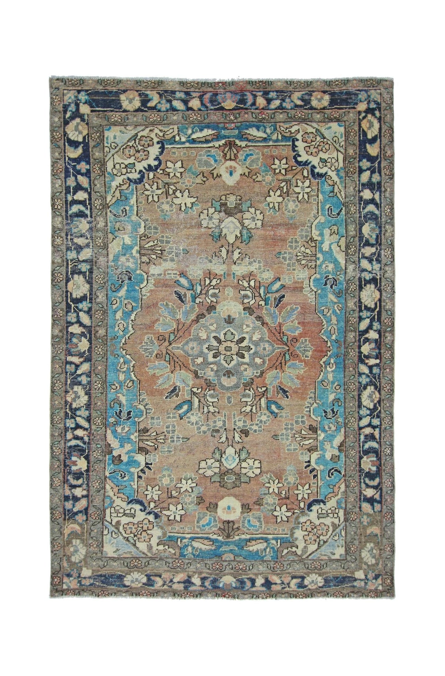A vintage Persian Tabriz rug featuring a central floral medallion on a muted orange field.