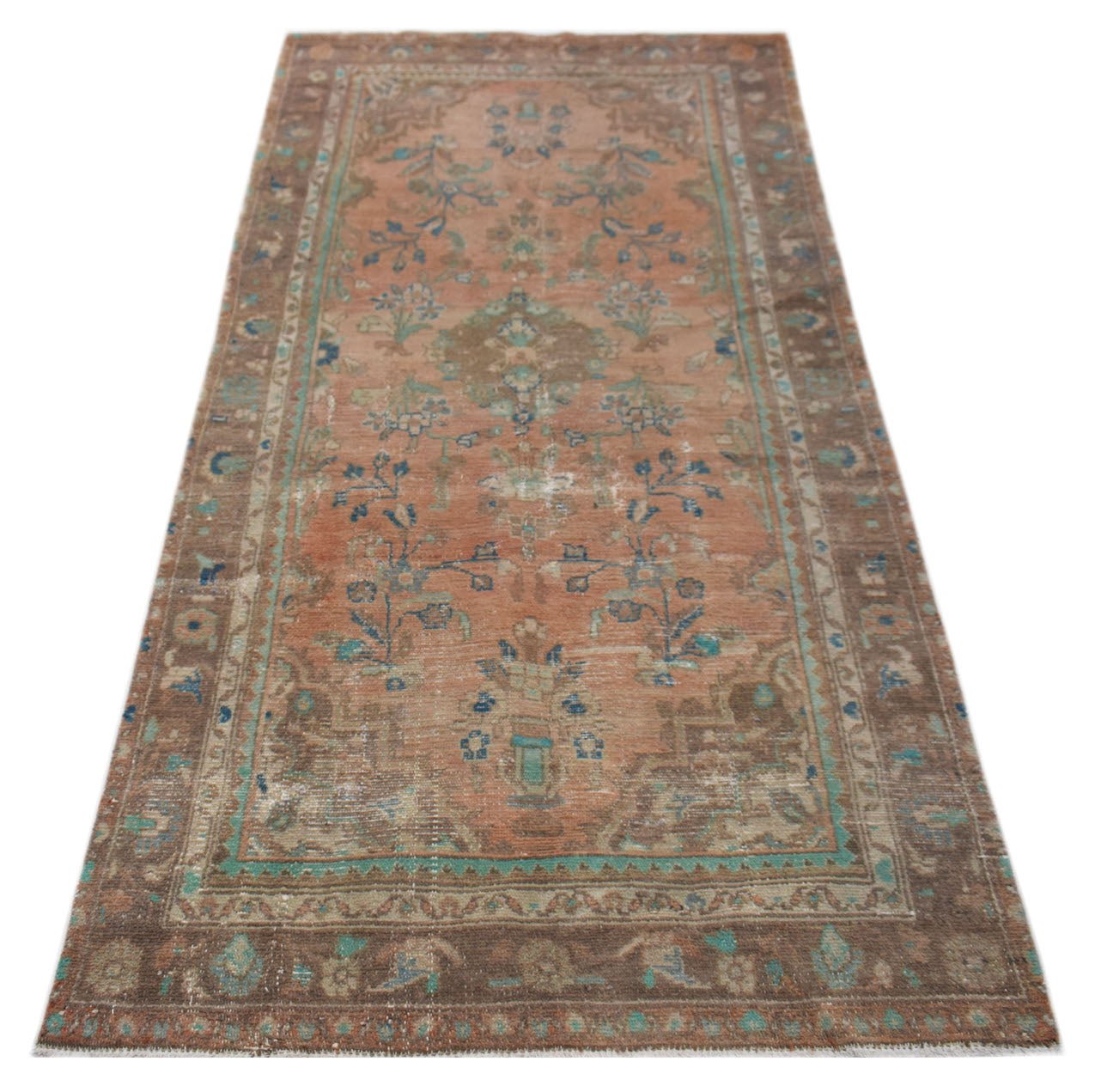 A vintage handwoven Persian Sarouk rug featuring floral patterns in faded orange, blue, and brown.
