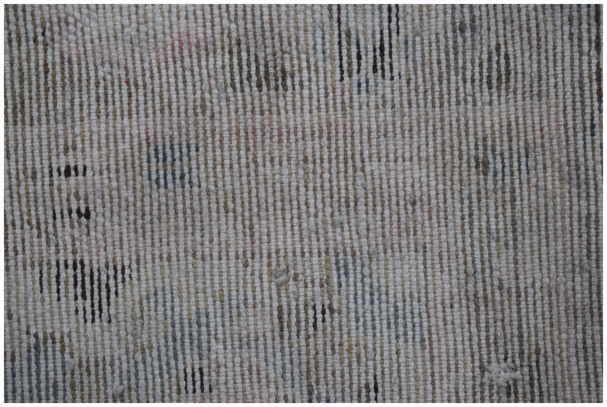 A close-up view of a vintage Persian Sarouk rug featuring a faded, handwoven wool texture.