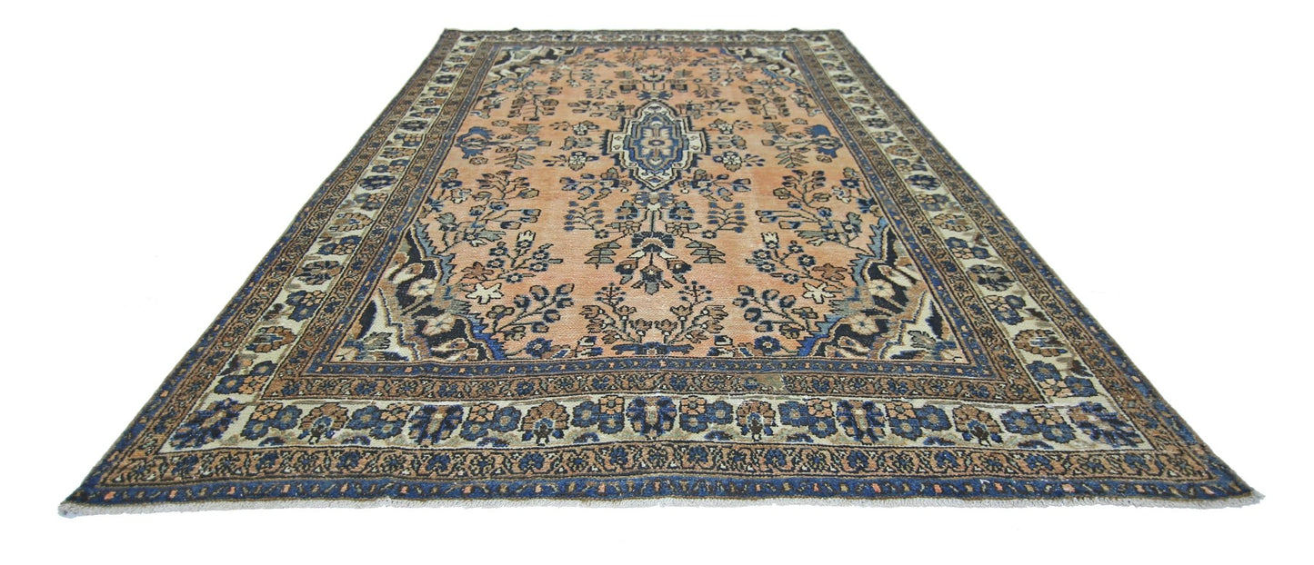 A vintage Persian Sarouk rug featuring a floral pattern in blue and peach tones.