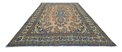 A vintage Persian Sarouk rug featuring a floral pattern in blue and peach tones.
