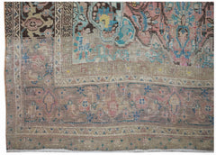 A handwoven vintage Persian rug featuring a faded floral pattern in muted pink, blue, and brown.