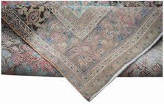 A handwoven vintage Persian rug featuring a faded floral pattern in muted pink and blue tones.
