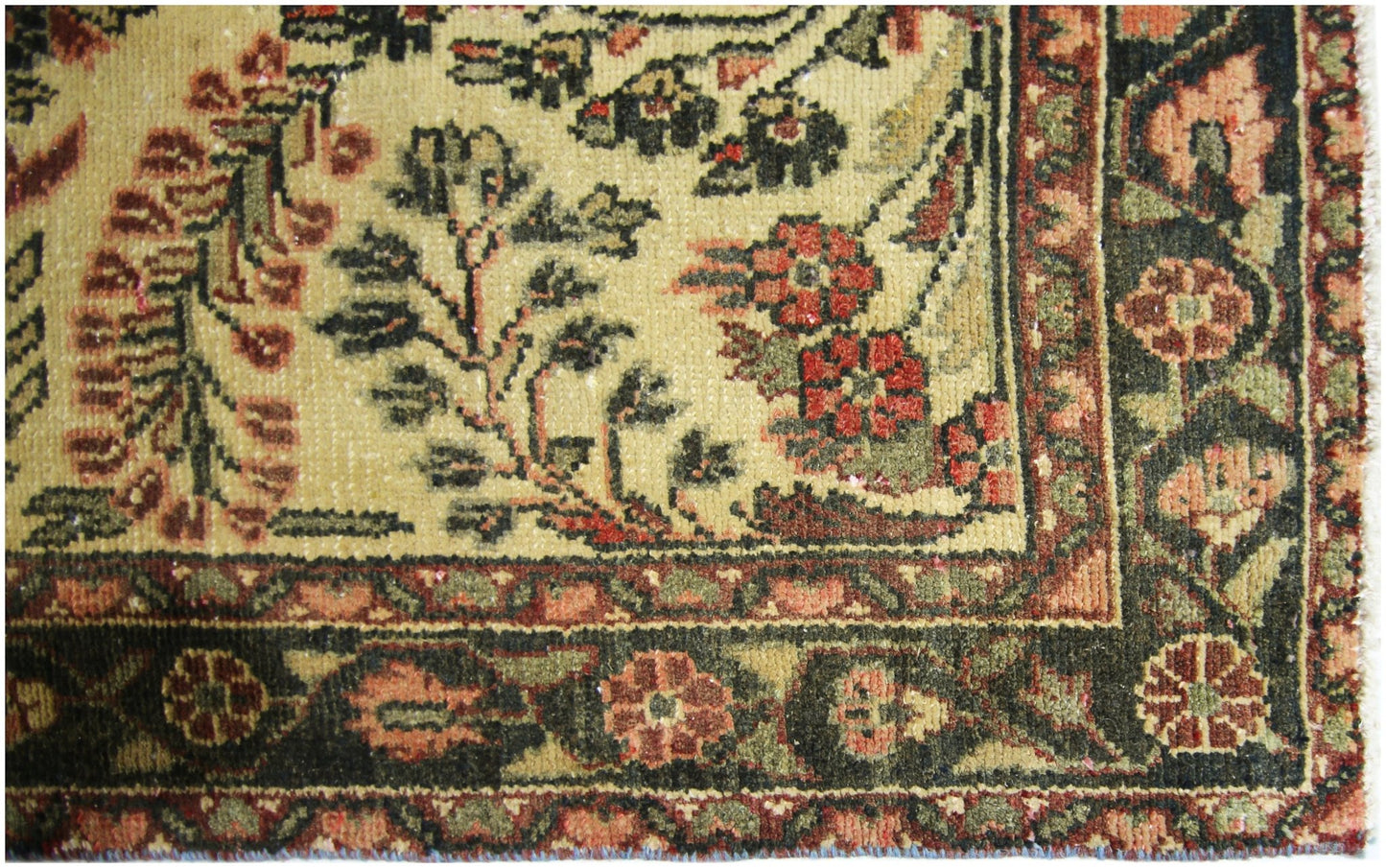 A close-up of a vintage Persian Sarouk runner featuring intricate floral patterns in wool.