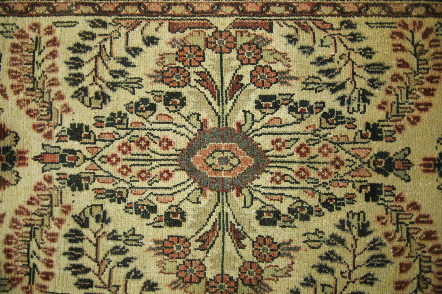 A vintage Persian Sarouk runner featuring a symmetrical floral medallion on a beige wool field.