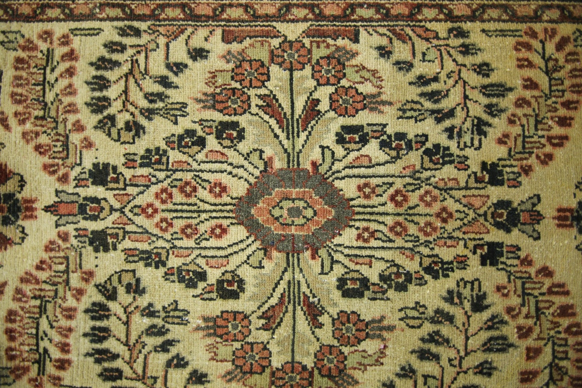 A vintage Persian Sarouk runner featuring a symmetrical floral medallion on a beige wool field.