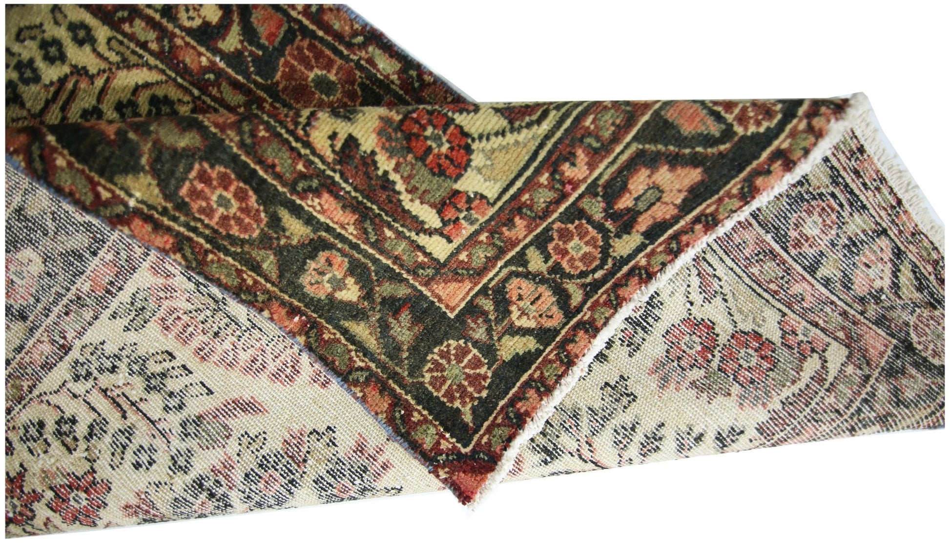 A vintage Persian Sarouk runner with a floral pattern in red, green, and cream wool.