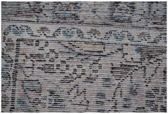 A close-up of a vintage Persian Sarouk runner featuring intricate floral patterns in muted tones.