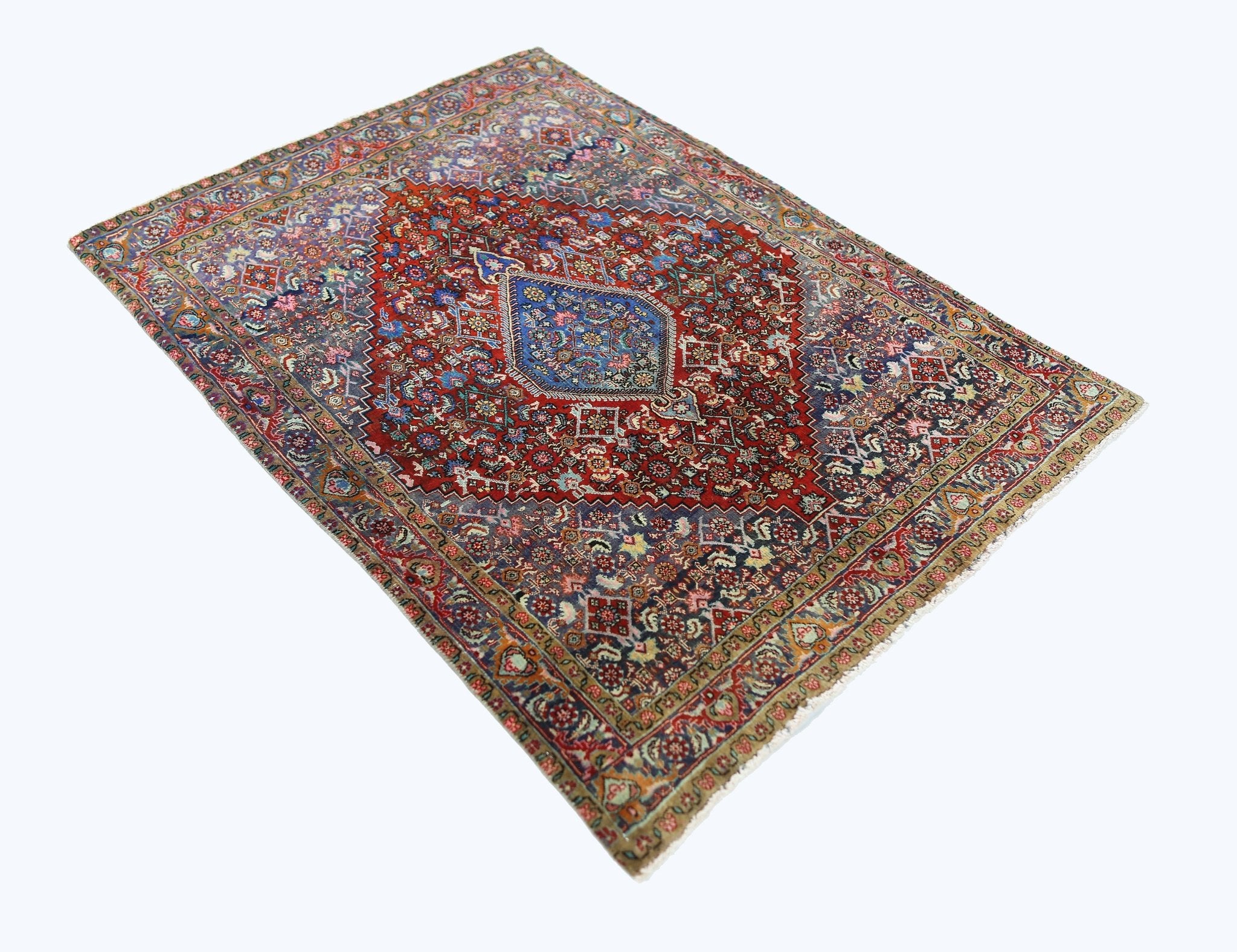 A vintage Persian Senneh rug featuring a central blue medallion on a detailed red floral field.