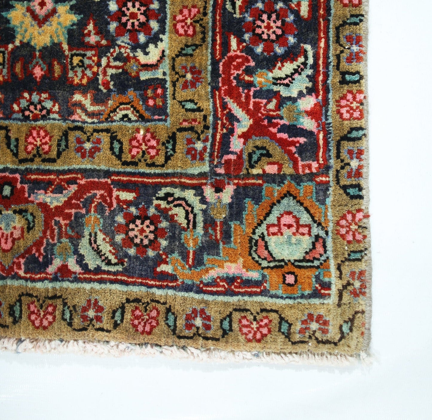 A vintage Persian Senneh rug featuring intricate floral patterns in red, blue, and gold tones.