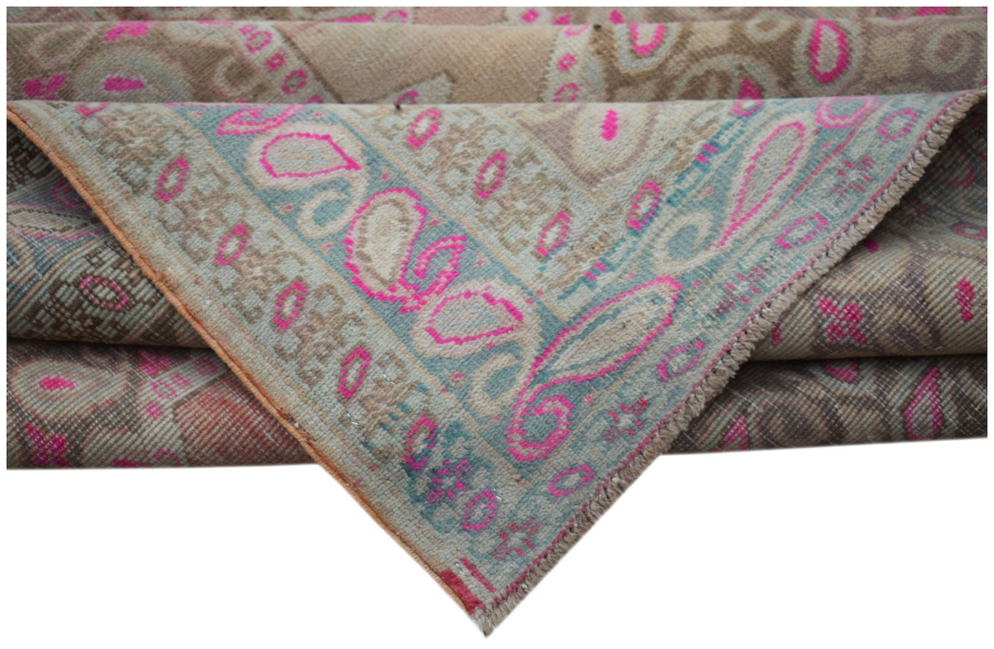 A vintage Persian Senneh rug featuring a faded paisley pattern in pink, blue, and beige tones.