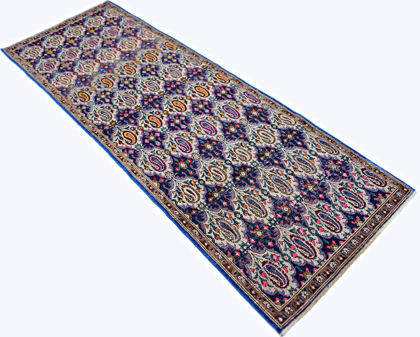 A vintage Persian Senneh runner rug featuring a detailed blue and cream paisley pattern.