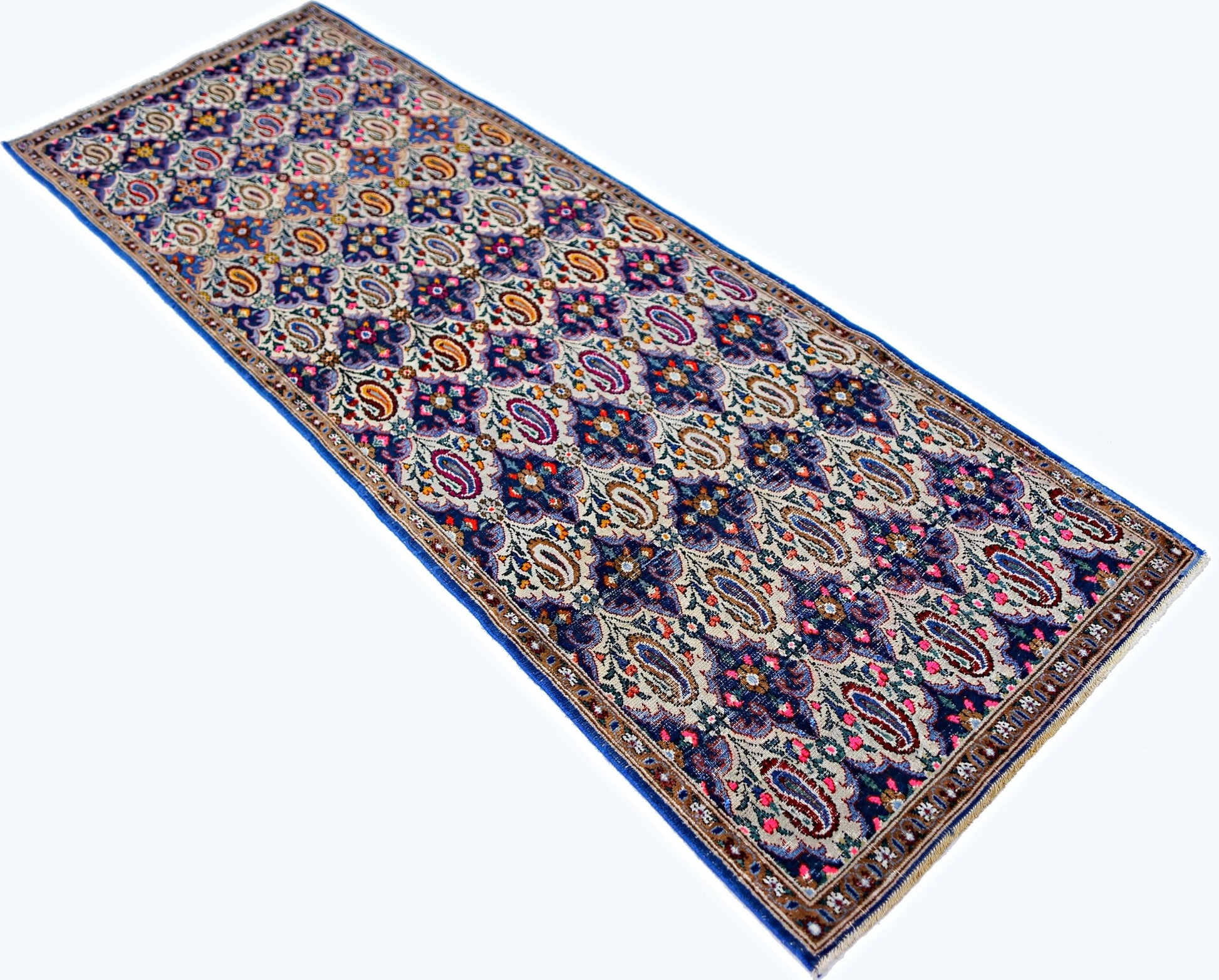 A vintage Persian Senneh runner rug featuring a detailed blue and cream paisley pattern.