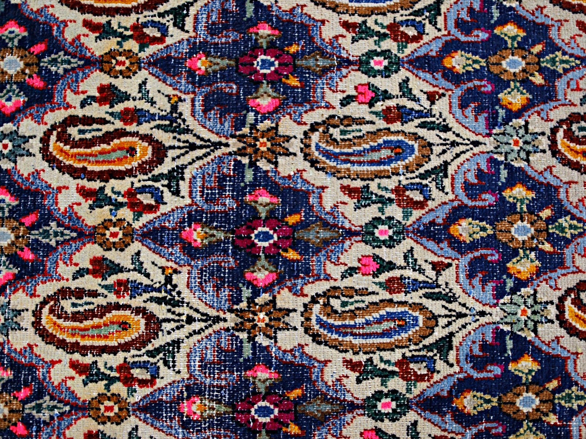 A vintage Persian Senneh runner featuring a detailed floral and paisley pattern in vibrant colors.