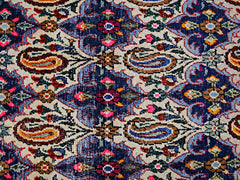 A vintage Persian Senneh runner featuring a detailed floral and paisley pattern in vibrant colors.