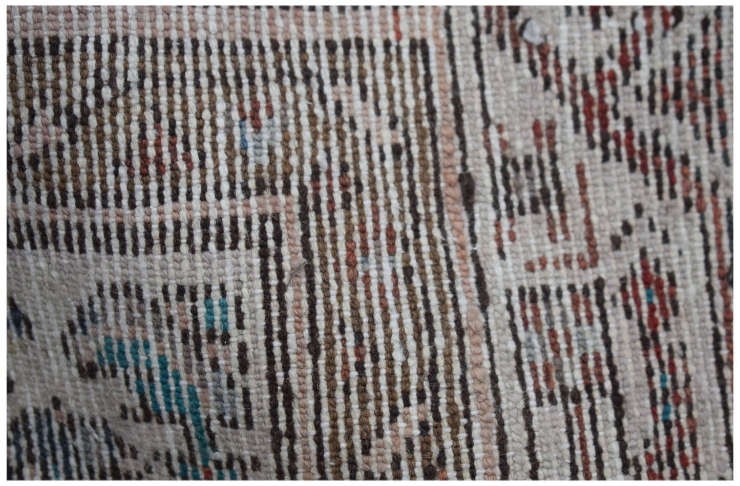 A close-up view of a vintage Persian Senneh runner featuring intricate geometric wool patterns.