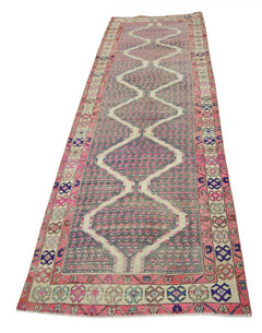 A vintage Persian Senneh runner rug featuring a grey field with a repeating white diamond pattern.