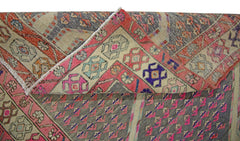 A vintage Persian Senneh runner featuring a geometric pattern in pink, grey, and blue tones.