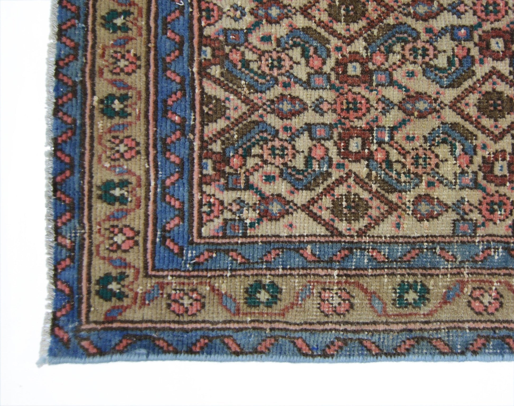 A vintage Persian Senneh runner featuring a detailed floral pattern in blue, pink, and brown tones.