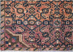 A vintage Persian Senneh runner featuring a geometric pattern in shades of pink, blue, and brown.