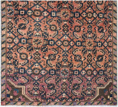 A vintage Persian Senneh runner featuring a geometric diamond pattern in red, blue, and brown.