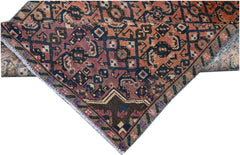 A vintage Persian Senneh runner featuring a geometric pattern in shades of red, blue, and brown.