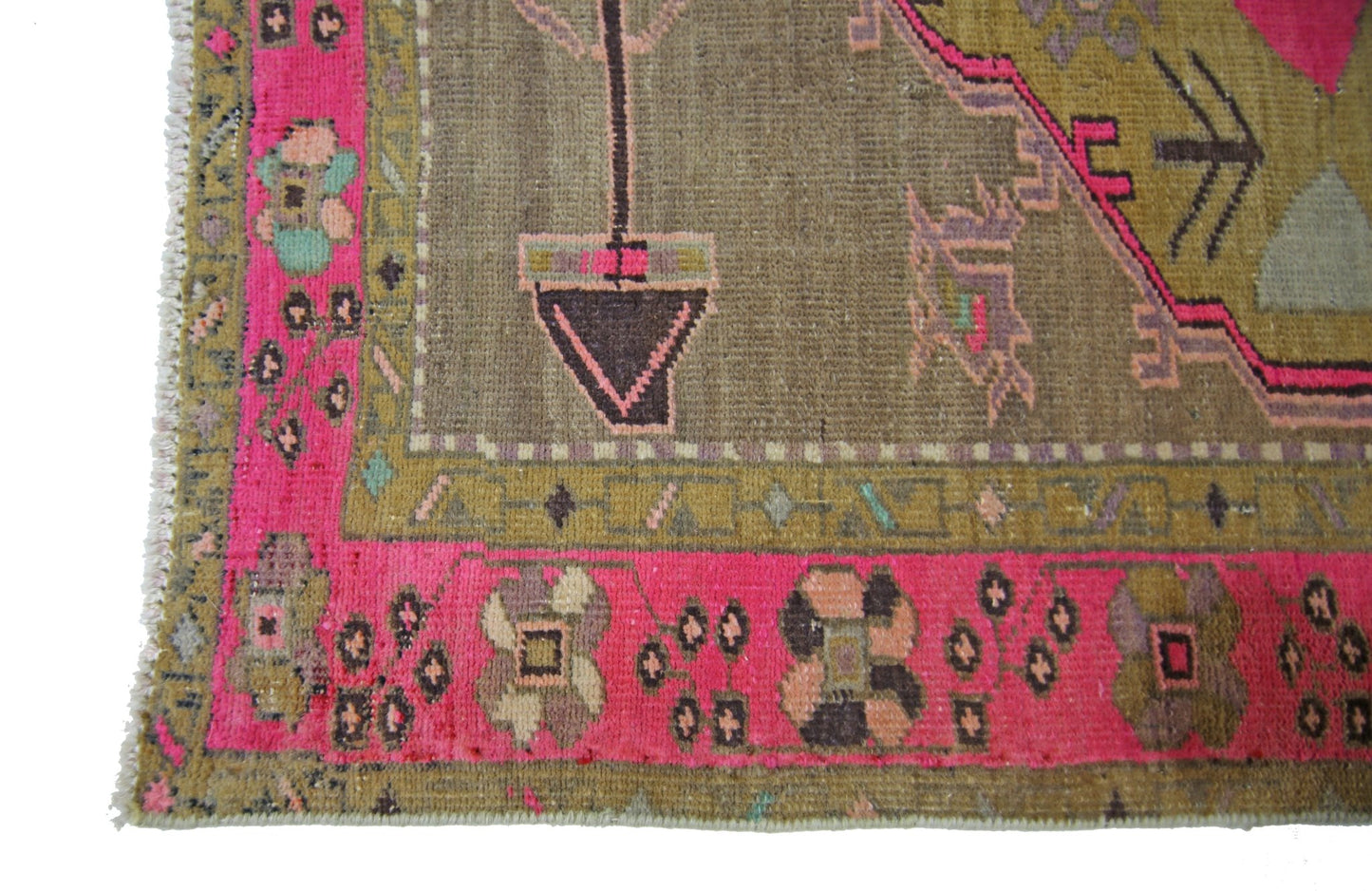 A vintage Persian Serab runner featuring a brown field with pink borders and geometric floral motifs.