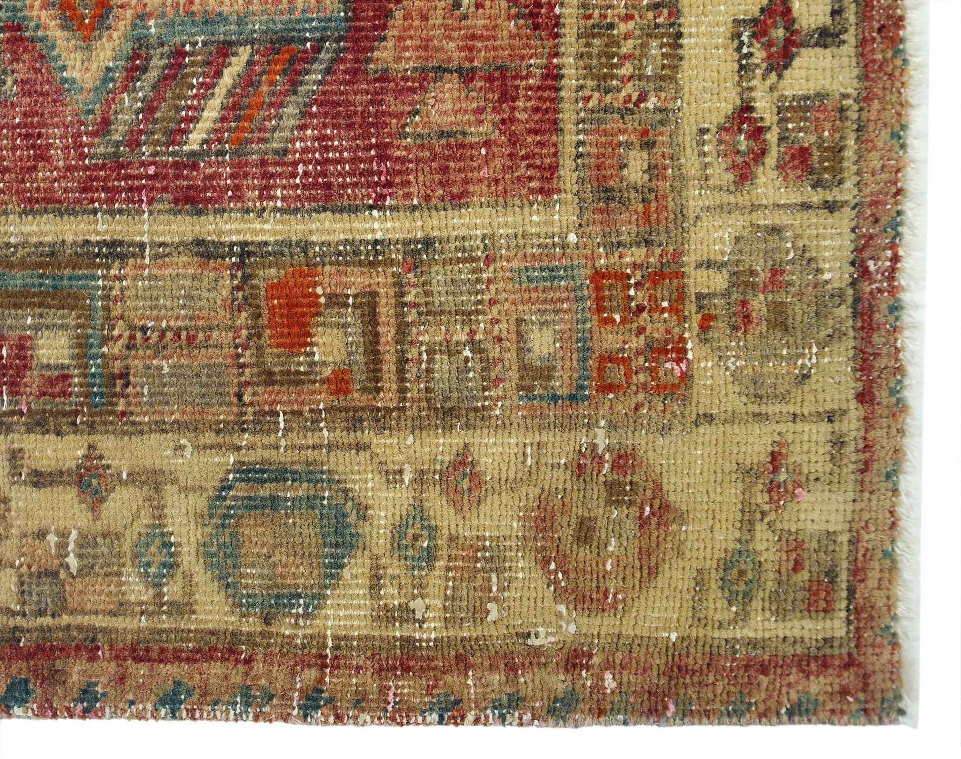 A vintage Persian Serab runner featuring geometric patterns in faded red, blue, and tan wool.